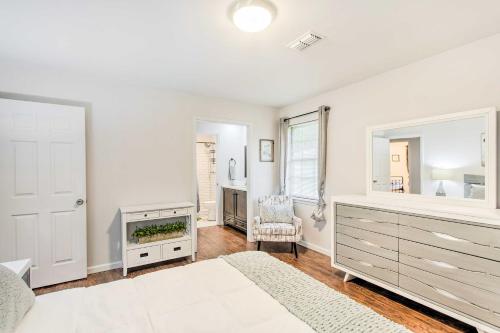 a white bedroom with a bed and a fireplace at Bright Hinesville Home, 43 Mi to Savannah! in Hinesville