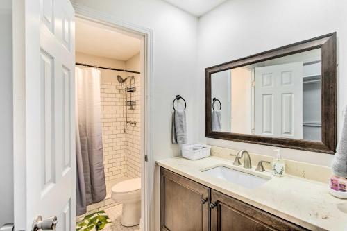 a bathroom with a sink and a toilet and a mirror at Bright Hinesville Home, 43 Mi to Savannah! in Hinesville