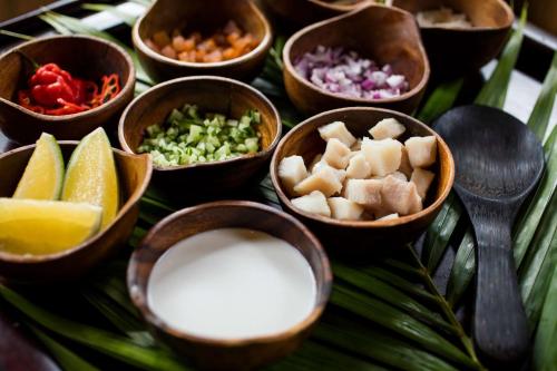 a bunch of bowls of food on a table at Outrigger Fiji Beach Resort in Korotogo