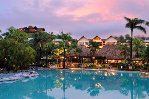 a view of a resort pool at dusk at Outrigger Fiji Beach Resort in Korotogo