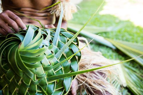 a woman is holding a palm plant at Outrigger Fiji Beach Resort in Korotogo