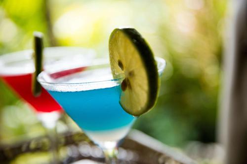 a blue drink with a slice of lime in a glass at Outrigger Fiji Beach Resort in Korotogo