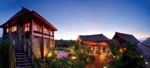 an exterior view of a house with lights at Outrigger Fiji Beach Resort in Korotogo