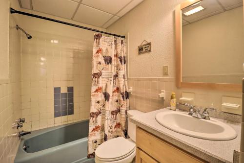 a bathroom with a sink toilet and a shower curtain at Lake Harmony Home with Game Room and Fire Pit! in Lake Harmony
