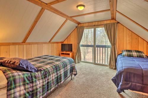 a bedroom with two beds in a room with a window at Lake Harmony Home with Game Room and Fire Pit! in Lake Harmony