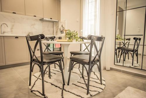 Apollo's Apartment on Radio City Midas Home في سلانيك: مطبخ مع طاولة وكراسي في غرفة