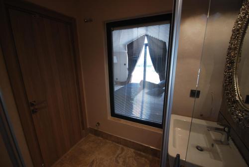 a bathroom with a window with a view of a building at S3 Seahorse Beach Club in Oludeniz