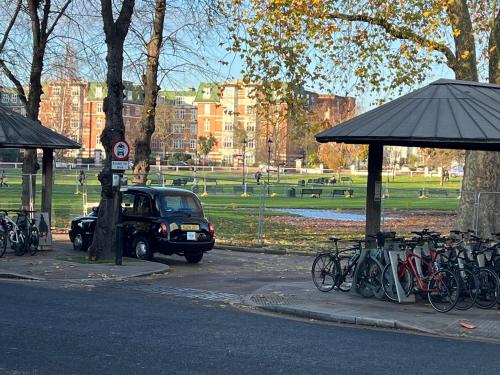 a car is parked next to a bunch of bikes at La Vie - Entire Apartment - Next to Central District Elizabeth line Tube Station - Near Central London & Wembley in Ealing