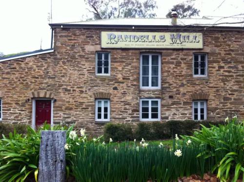 a brick building with a sign on the front of it at Randell's Mill - Adelaide Hills - Romantic Loft Stays in Gumeracha