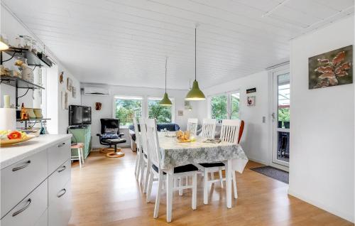 a kitchen and dining room with a table and chairs at 2 Bedroom Lovely Home In Sæby in Sæby