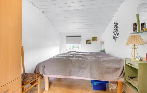 a bedroom with a bed and a window at 2 Bedroom Lovely Home In Sæby in Sæby