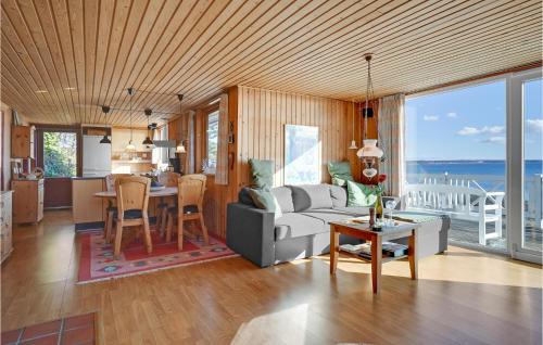 a living room with a couch and a table at 2 Bedroom Gorgeous Home In Ebeltoft in Ebeltoft