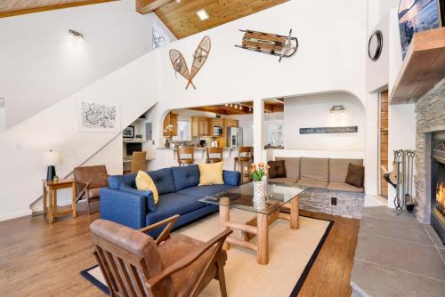 a living room with a blue couch and a fireplace at 2010-Lassen Paradise home in Big Bear Lake