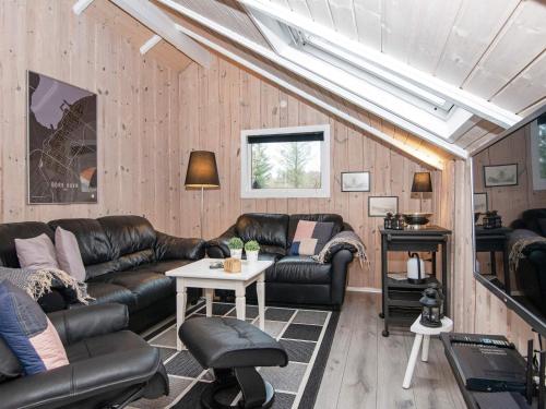 a living room with leather furniture and a skylight at 6 person holiday home in Hemmet-By Traum in Hemmet