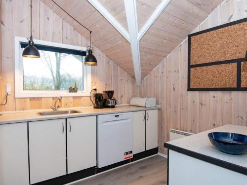 a kitchen with white cabinets and a window at 6 person holiday home in Hemmet-By Traum in Hemmet