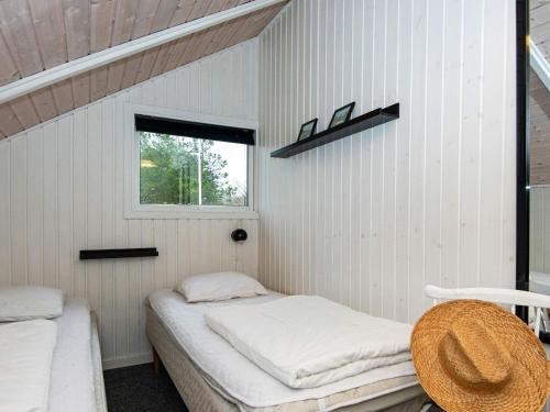 two beds in a room with a window at 6 person holiday home in Hemmet-By Traum in Hemmet