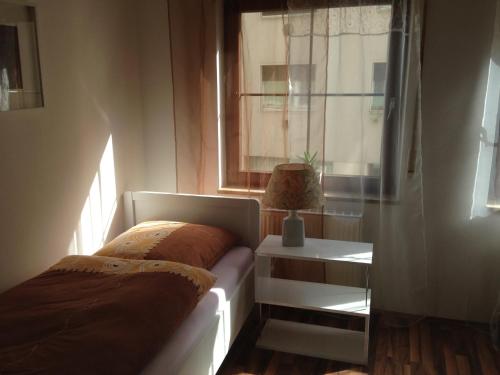 a bedroom with a bed and a window at Apartment Nürnberg City-Center in Nuremberg