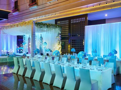 a banquet hall with white tables and chairs at InterContinental Shanghai Pudong by IHG in Shanghai