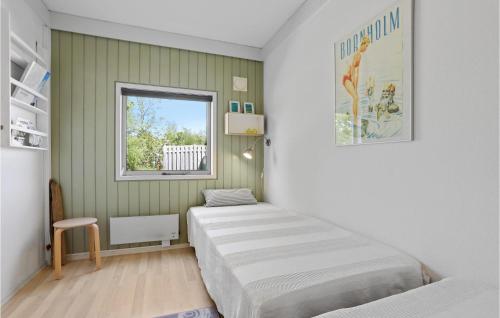 a bedroom with two beds and a window at Hasle Feriepark 53 in Hasle