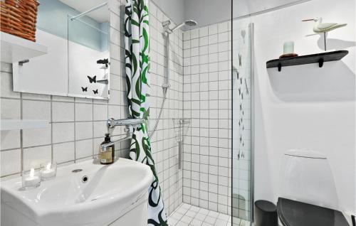 a white bathroom with a sink and a shower at Hasle Feriepark 53 in Hasle
