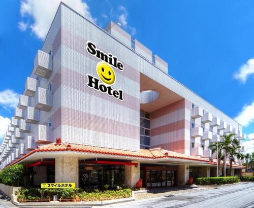 a hotel with a smiley face on the side of it at Smile Hotel Naha City Resort in Naha