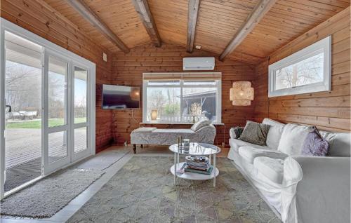 a living room with a couch and a table at Stunning Home In Kruså With Wifi in Kruså