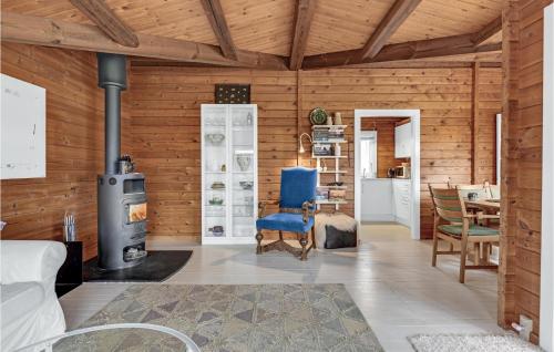 a living room with wooden walls and a stove at Stunning Home In Kruså With Wifi in Kruså
