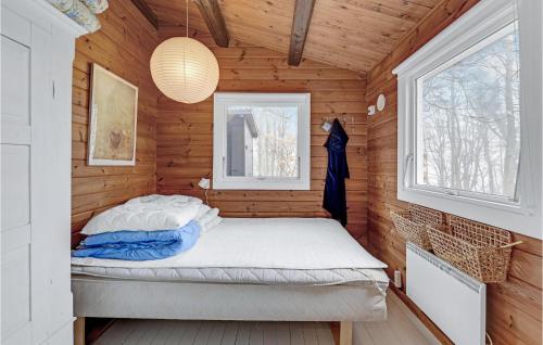 a bedroom with a bed in a wooden cabin at Gorgeous Home In Krus With Wifi in Kruså