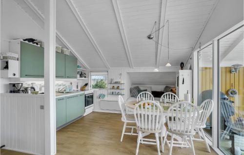 a kitchen and dining room with a table and chairs at Lovely Home In Roslev With Kitchen in Roslev
