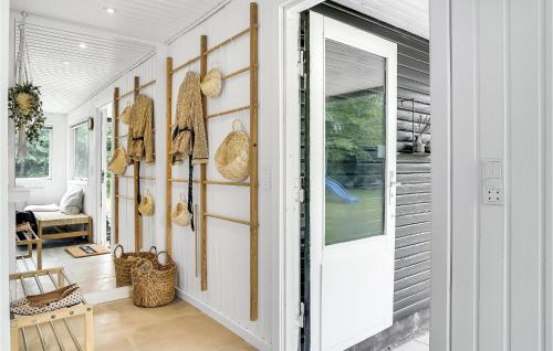 a hallway of a home with a door and baskets at Pet Friendly Home In Hals With Kitchen in Hals