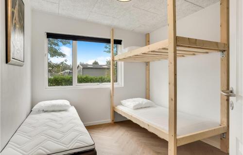 a bedroom with two bunk beds and a window at Awesome Home In Nibe With Kitchen in Nibe