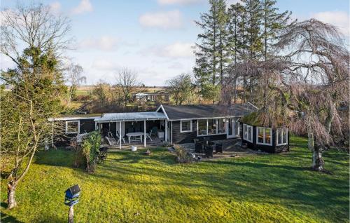 a house in the middle of a yard at Beautiful Home In Orø With Wifi in Orø