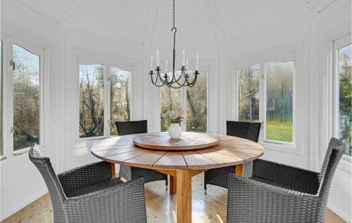 a dining room with a wooden table and chairs at Beautiful Home In Orø With Wifi in Orø