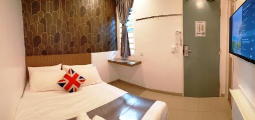 a bedroom with a bed with a pillow on it at Garden 96 inn in Kuantan