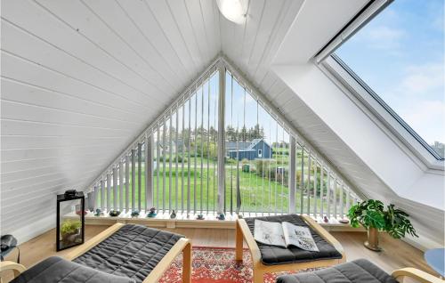 an attic living room with a large window at 3 Bedroom Beautiful Home In Vemb in Vemb