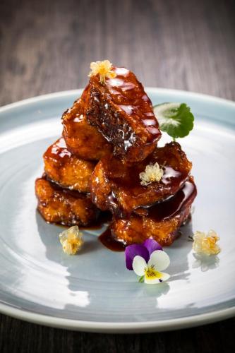 a stack of food on a white plate with flowers at InterContinental Shanghai Wonderland by IHG in Songjiang