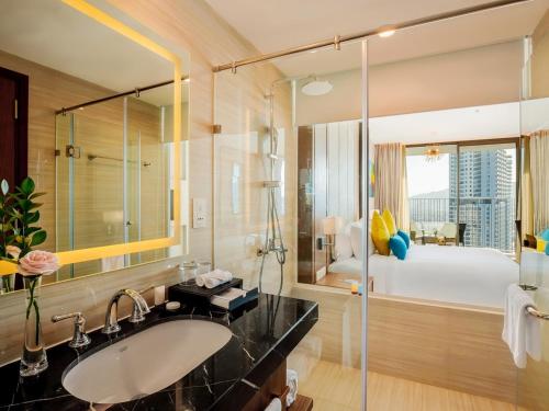 a bathroom with a sink and a large mirror at PANORAMA Condotel by HLG in Nha Trang