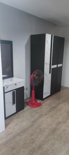 a kitchen with a red chair in a room at Old Town in Jomtien Beach