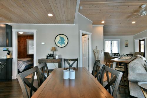 a dining room with a wooden table and chairs at Spruce Haven home in Hayward