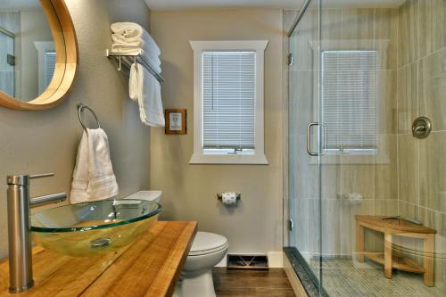 a bathroom with a glass bowl sink and a shower at Spruce Haven home in Hayward