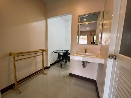 een badkamer met een wastafel en een spiegel bij The Passion Nest - SHA Plus Certified in Phuket