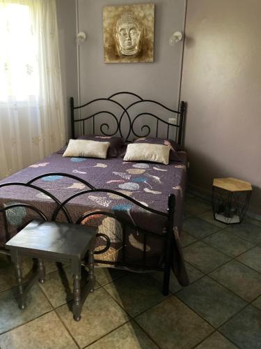 a bedroom with a bed with a skull picture on the wall at KAZE SILAS in Saint-Joseph