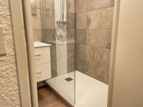 a shower with a glass door in a bathroom at Studio coin montagne calme, 4 pers, parking, Risoul 1850 - FR-1-330-92 in Risoul