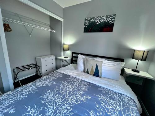 a bedroom with a bed with a blue and white comforter at Canadian Rockies Chalets in Canmore