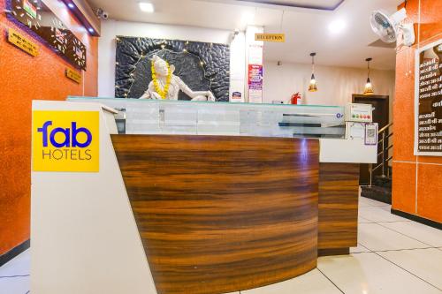 a restaurant with a wooden counter top in a store at FabHotel Satyug Jaisinghpura in Ujjain
