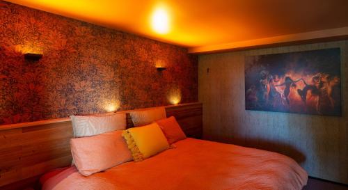 a bedroom with a large bed with an orange ceiling at The Upside Down in Nelson