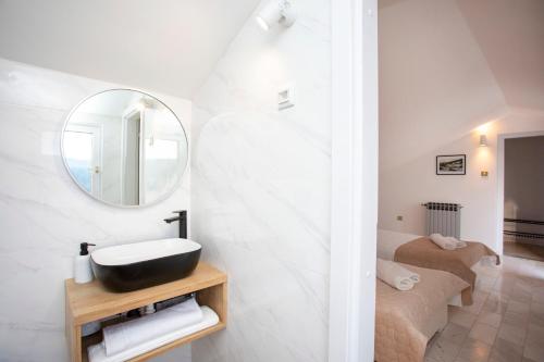 a bathroom with a sink and a mirror at La casa di Marko in Rabac
