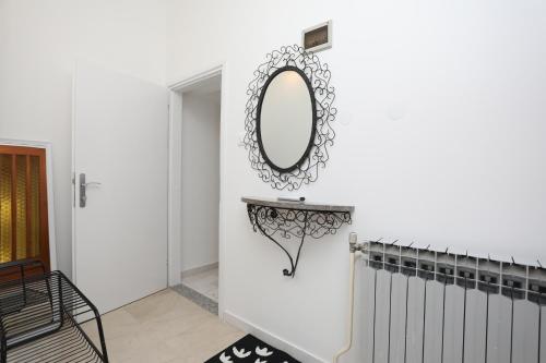 a mirror on a wall next to a hallway at La casa di Marko in Rabac