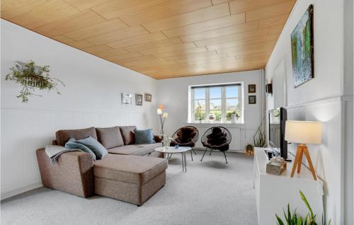 a living room with a couch and a table at Awesome Apartment In Hejls With Kitchen in Hejls