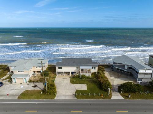 an aerial view of a house and the ocean at White Heron Beach House in Ponte Vedra